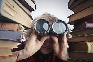 A man looking through binoculars looking for prove link-building tactics.