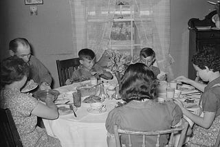 Rothstein, A., photographer. (1939) Farm family at dinner. Fairfield Bench Farms, Montana. Montana Fairfield Bench Farms United States Teton County, 1939. May. [Photograph] Retrieved from the Library of Congress, https://www.loc.gov/item/2017777606/.
