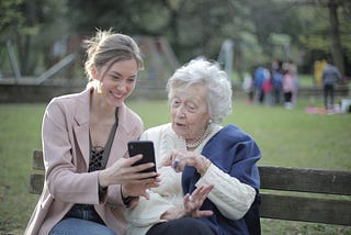 Speaking with eldery relative on park bench