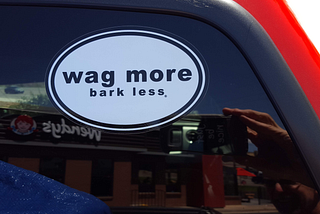 Image of a sticker on the back of a truck. Photo taken with my mobile phone. You can see my phone in my hand at the bottom right of the photo.