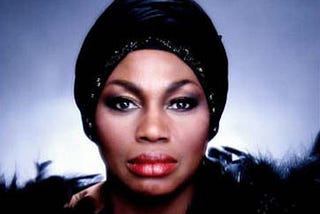 Color photo of Leontyne Price wearing a black turban.