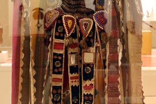 The image features an Egungun mask from Nigeria from ca. 1950