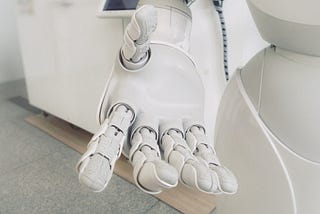 AI Writing Assistant Jasper AI. AI Robot Hand.