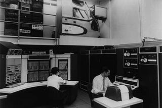 Two men in a computer room in the 1970s