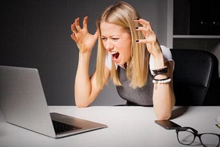 woman views computer, looking at mistake