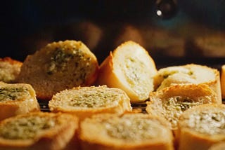 Garlic bread bites situated beside each other.