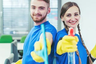 Two commercial cleaners with their cleaning equpiment