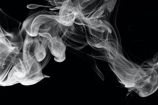 Horizontal puff of smoke set against a black background.