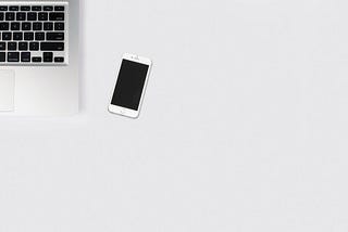 smartphone and laptop on a white background.