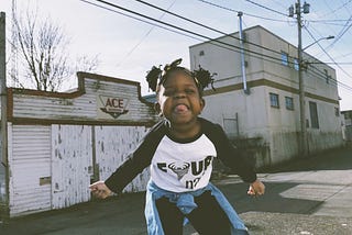 A little girl showing her toungue