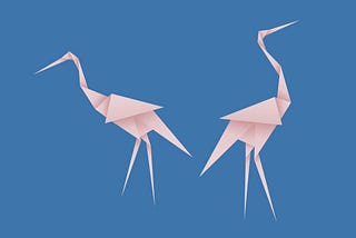 A photo of two pink flamingo paper origamis.