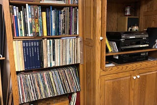 Bookshelf with records and art books, along with the record player to the right.
