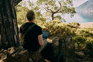 A guy typing away at a mountain.