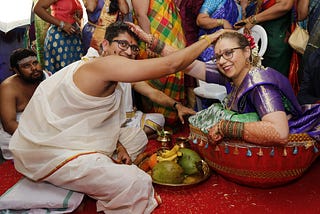 The writer and her husband during their Telugu hindu wedding at the stage of Jeelakarra Bellam