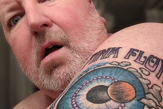 Author self portrait with Pink Floyd tattoo on shoulder
