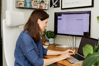 A woman auditing her designs on her computer.