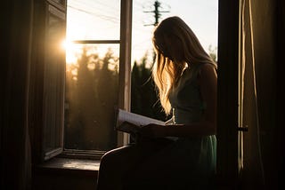 Woman reading by the sunlight. Photo by Yuri Efremov on Unsplash