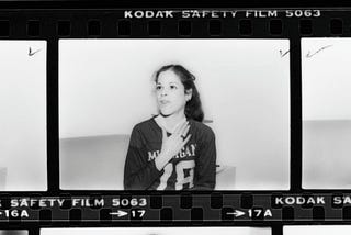 Film strip of Gilda Radner gesturing with her hands and smiling