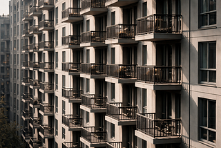 Repeating balconies on a modern apartment building with soft, even light.
