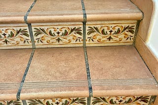 Tile stairs with decorative accent tiles.