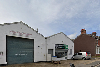 Southampton Special Purpose Workshop viewed from the front, a white building with grey shutters.