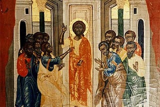 Black disciples gather around black Jesus who has a halo surrounding his head. The disciples are bowing slightly