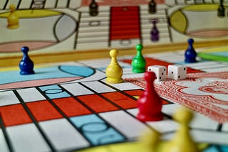 Board game with colorful pieces and a pair of die