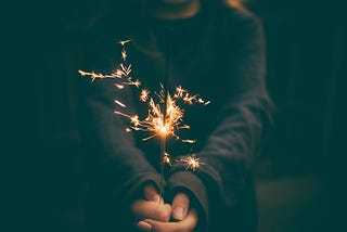 Sparkler — tiny fireworks held by a man