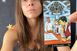 Rozalia Kieliszkiewicz holding the Three of Pentacles, Minor Arcana Tarot Card.