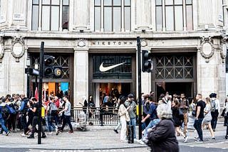 Image of NikeTown London’s storefront on Oxford Street with people walking past.