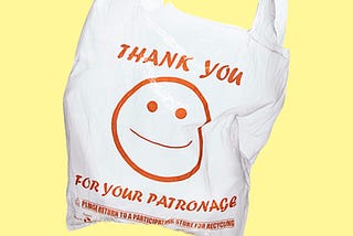 A disposable shopping bag printed with a smiling face and the message “thank you for your patronage”