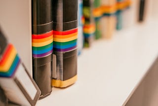 Shelf with LGBTQ awareness books at the public library. Photo by Christina Vartanova from Shutterstock.