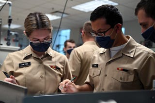 Students at Naval Nuclear Power Training Command (NNPTC), solve equations in a fluid theory lab.