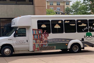 The Book Buggie mini-bus parked to offer free books for families