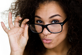 Black woman wearing glasses.