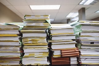 Several tall stacks of paper in folders