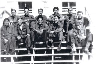 A group of Comanche soldiers in uniform sitting for a photo