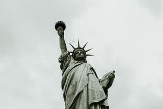 Black and White or Sepia color looking upward at the statue of liberty in America.