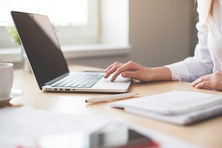 A woman typing on her laptop