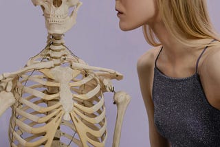 girl looking closely at skeleton