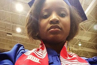 a girl in a blu cap and gown for graduation