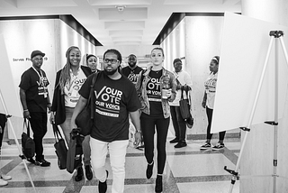 Members of the Florida Rights Restoration Coalition walk through the halls of the Florida State Capitol on their way to meet with elected officials during Advocacy Day.