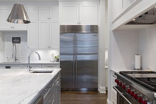 Minimalist white kitchen with modern appliances