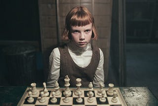 little girl playing chess