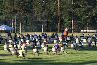 New England Town Meeting on baseball field during COVID-19 pandemic