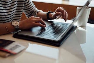 A person typing on a laptop computer.