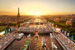 Vue aérienne de la Seine et des bateaux y défilant en arborant les drapeaux de leurs pays.