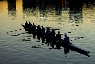 A team of rowers rowing a canoe