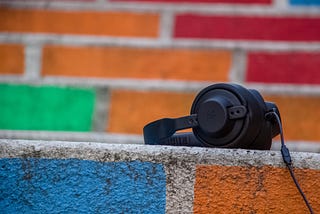Black headphones on a multicoloured wall