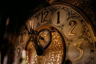 Close-up of an ornate vintage clock face in warm, low light, symbolizing time pressure and urgency. Photo by Nguyen Mazic on Unsplash